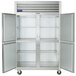 A white Traulsen G Series reach-in refrigerator with two open doors.
