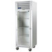 A Traulsen G Series glass door reach-in refrigerator with a white cabinet.