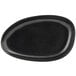 A black oval shaped Front of the House Kiln porcelain plate.