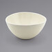 A white Front of the House Kiln oval tall porcelain bowl on a gray surface.