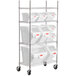 A metal rack with white Rubbermaid ingredient bins on shelves.