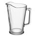 An Arcoroc clear glass beer pitcher with a handle.