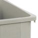 A beige Carlisle Trimline 23-gallon rectangular trash can with a trimline® caddy.