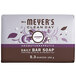 A bar of Mrs. Meyer's lavender soap with purple and white packaging on a counter.