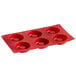 A red silicone cake pan with six savarin molds.