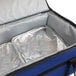 A Sterno blue insulated food carrier with silver foil inside.
