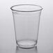 A clear plastic Fabri-Kal customizable cup on a white surface.