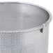 A close up of a stainless steel Robot Coupe perforated basket with holes in it.