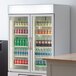 A white Beverage-Air marketmax refrigerator with glass doors filled with drinks and beverages.