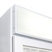 A white Beverage-Air glass door freezer with a light on it.