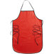 A red San Jamar EZ-KLEEN apron with black straps on a counter.