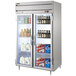 A Beverage-Air Horizon Series glass door reach-in refrigerator with bottles of beer and milk.