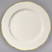 A CAC ivory china plate with scalloped edges and gold trim.