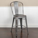 A Flash Furniture distressed silver metal counter height stool with a vertical slat back and drain hole seat.