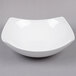 An American Metalcraft white stoneware bowl on a gray surface.