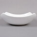 An American Metalcraft square white stoneware bowl with a curved edge.