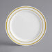 A white plastic plate with gold bands on the rim.