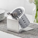 A Steril-Sil stainless steel flatware organizer with gray perforated cylinder holding spoons.