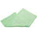A green towel folded on a white background.