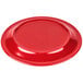 A red Carlisle melamine plate on a table.