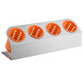 A white rectangular Steril-Sil flatware organizer with orange perforated plastic cylinders.