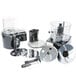 The clear bowl, continuous feed attachment, and discs for a Waring commercial food processor.