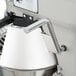 A Globe commercial stand mixer with metal accessories.