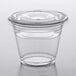 A Choice clear plastic squat cup with an insert and flat lid on a table.