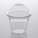 A Choice clear plastic squat cup with a PET dome lid on a table.