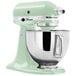 A mint KitchenAid Artisan Series stand mixer with a bowl attached.