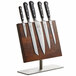 A Mercer Culinary Renaissance knife set on a wooden board with a stainless steel base.