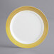 A white Visions plastic plate with a gold lattice design.