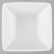 An American Metalcraft white square bowl on a gray surface.