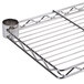 A Metro stainless steel cantilever overhead shelf on a metal rack.