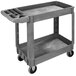 A gray plastic Carlisle utility cart with two shelves and wheels.
