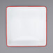 A white square plate with red trim.