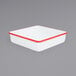 A white square enamel cake pan with red trim.