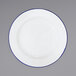 A Crow Canyon Home white enamelware plate with blue rim.