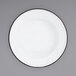 A close-up of a Crow Canyon Home white enamelware plate with a black rim.