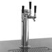 An Avantco stainless steel beer tap with black handles on a counter.