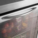 A Turbo Air undercounter refrigerator with a glass door filled with apples.