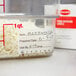 A container of rice sits on a counter next to a Cambro StoreSafe dissolvable label.