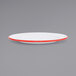 A white Crow Canyon Home enamelware plate with red rim.