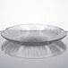 A clear glass dessert plate with a ripple pattern on it.