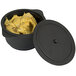 A black Solia plastic cooking pot with an open lid filled with food.