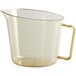A clear plastic measuring cup with a gold handle.