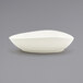 A white Front of the House Tides scallop oval bowl on a gray surface.