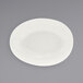 A white scallop oval porcelain bowl with a round surface.
