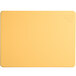 A yellow rectangular Tomlinson Chef's Edge cutting board with a logo on it.