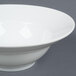 A white CAC porcelain mixing bowl on a gray surface.